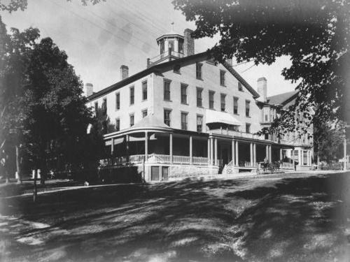 A black and white historic image of the exterior of the Inn